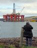 Calum Davidson taking photo of Borgsten Dolphin as it gets ready to leave the Cromarty Firth