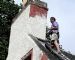 Gillian Newman painting her chimney